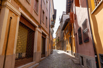 Medieval cobblestone street in Udine with traditional houses and rustic charm © Sanja