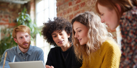 Business professionals in a creative loft office discussing a new project. Cooperation in business and teamwork concept.