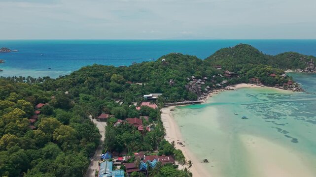  Chalok Baan Kao, Koh Tao, Thailand Aerial drone pan beach and jungle, sand blue turquoise water.