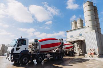 Concrete mixer trucks loading at a concrete production plant