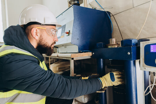 Construction engineer testing concrete strength in laboratory using press machine