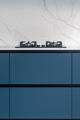 Linear kitchen. Black hob. Blue cabinetry
