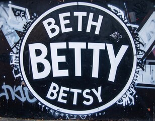 Black circle with white text on graffiti wall