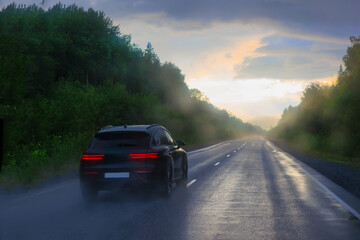 Car driving on wet country road after rain