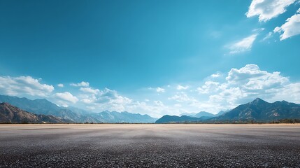 A wide-angle ground with a clear sky and mountainous background for vehicles or products placement. Copy space image. Place for adding text or design ... See More.