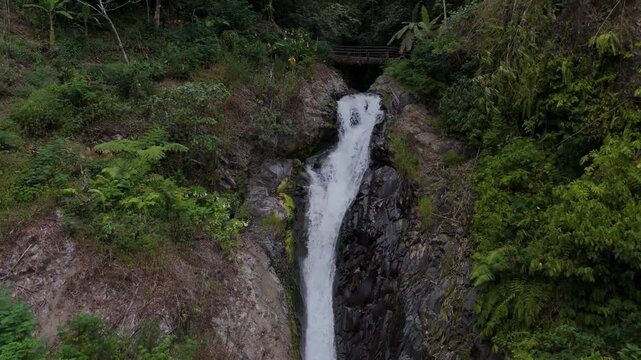 Waterfall from GitGit waterfalls in Bali Indonesia filmed with an aerial drone during summer. 