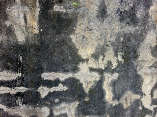 Concrete wall texture with weathered patterns created by natural conditions