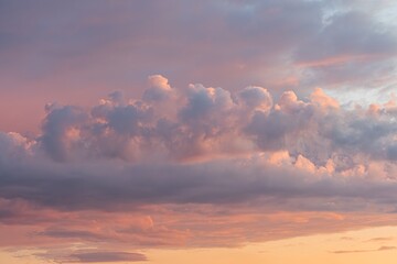 Orange, pink, purple skyscape at dusk or dawn, no horizon line, upward perspective, soft focus, pastel tones, realistic style, tranquil atmosphere
