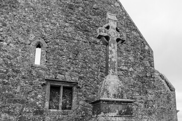 A stone building with a cross on top of it