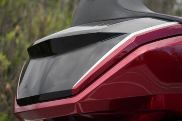 Red motorcycle parts details close up, shapes and forms of aerodynamic, cruiser moto 