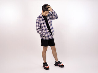 Fototapeta premium young man posing casually in trendy outfit against a plain background