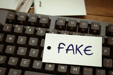 There is word card with the word FAKE. It is as an eye-catching image.