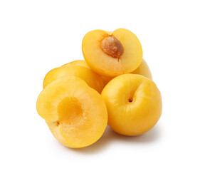 Whole and cut yellow cherry plums isolated on white