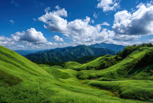A picturesque scene of vast green hills under a bright blue sky filled with fluffy clouds, showcasing a serene natural landscape.