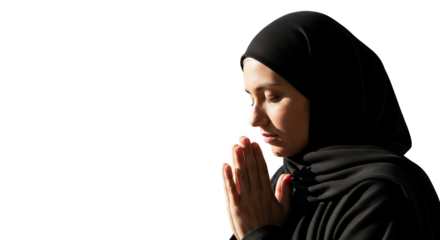 Serene contemplation: A woman in a hijab seeks spiritual solace through quiet meditation and prayerful reflection in black garment