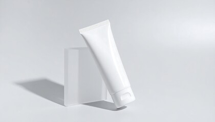 White Gel Cleanser Tube Leaning On Clear Acrylic Block with High Key Lighting on White Background