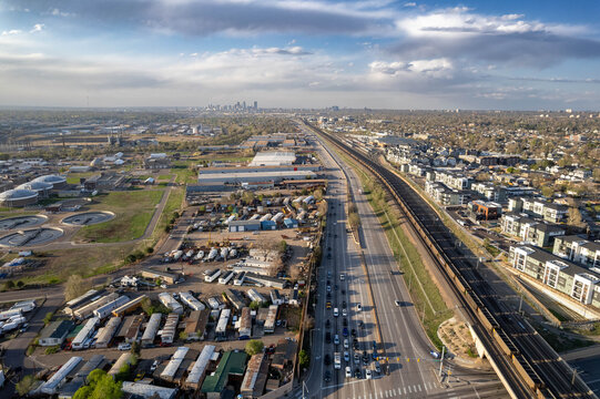 Aerial view of highway interchange and suburban development in Englewood with Denver skyline visible in distance, Colorado, USA