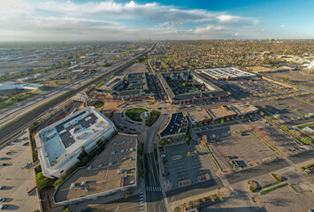 Aerial view of highway interchange and suburban development in Englewood with Denver skyline visible in distance, Colorado, USA