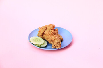 Fast Food Fried Chicken on a plate with a pink background