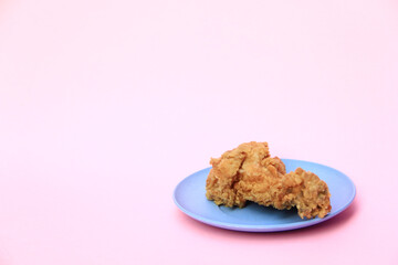 Fast Food Fried Chicken on a plate with a pink background