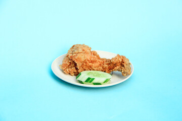 Fast Food Fried Chicken on a plate with a blue background