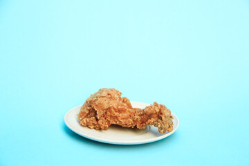 Fast Food Fried Chicken on a plate with a blue background