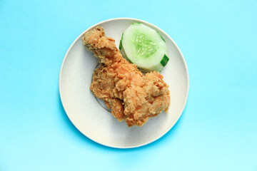 Fast Food Fried Chicken on a plate with a blue background