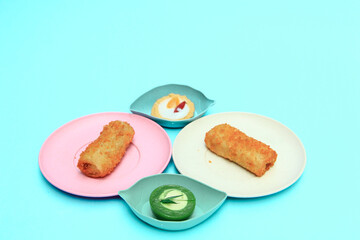 Indonesian risol cakes, talam cakes and pie cakes are displayed on a blue background, highlighting their unique textures and colors.