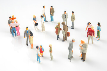 Miniature people gathering in a lively urban setting during daytime social interactions