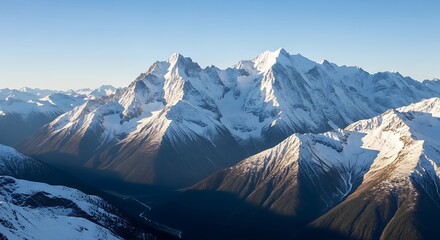 Majestic snowy mountain peaks with clear sky, representing wilderness and adventure.
