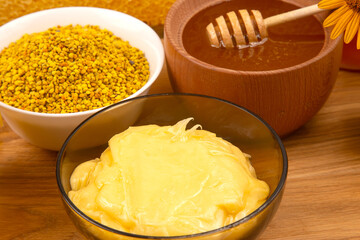 Discovering natural bee products like honey, pollen, and beeswax in a rustic kitchen setting