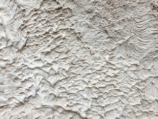 Textured surface showing intricate patterns created by natural elements in a dry environment