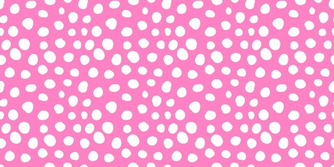 Aesthetic pattern of white dots of different sizes on a pastel pink background. 