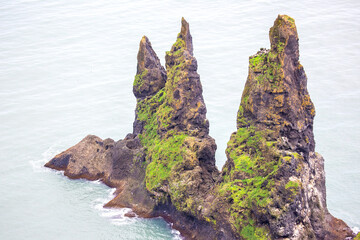 Majestic sea stacks rise from the ocean near Vik, Iceland, showcasing nature's beauty and power