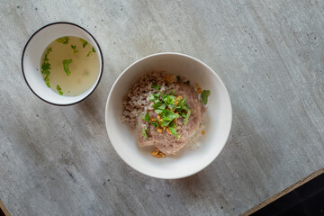 Gourmet Delight: A top-down perspective showcases a culinary masterpiece, presenting a bowl of appetizing rice. The composition also features a small bowl filled with flavorful soup.