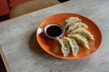 Dumplings Delight: A culinary still life showcases a vibrant plate of freshly steamed dumplings...