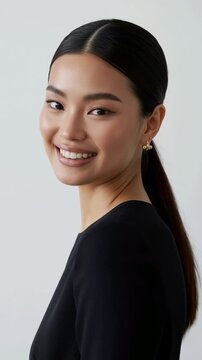 Close-up portrait of a young woman smiling warmly with natural joy. Soft lighting enhances her features, capturing genuine beauty and positive emotion.458