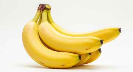 Fresh, ripe, yellow bananas in a healthy bunch, beautifully arranged on a bright white backdrop