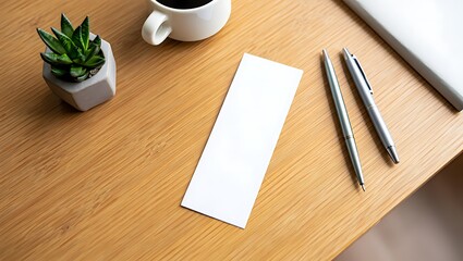 Blank white receipt or note paper sits on a light brown wooden desk, next to a small succulent plant, a coffee cup, and pens.