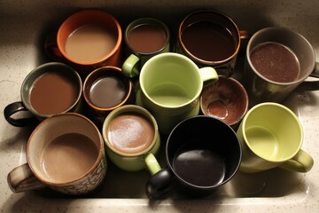 Assorted Coffee Cups In Sink