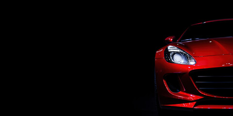 Close-up of red luxury sports car headlight in dark studio lighting