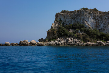 Naklejka premium Scenic rocky island in the mediterranean sea on sunny day and blue sky. Turquoise water and bright summer atmosphere