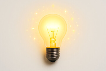 Bright incandescent light bulb glowing warm yellow light symbolizing ideas innovation and energy