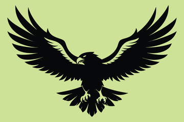Obraz premium Powerful black eagle silhouette soaring with wings spread wide against a serene light green background