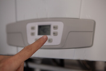 Obraz premium Close up of finger pressing a button on the air conditioner.
