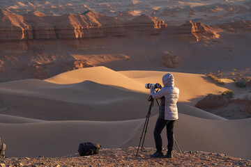 Photographer Capturing the Beautiful and Serene Desert Landscape During Sunrise