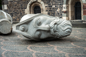 Fallen Stone Statue Head Outside Historic Building