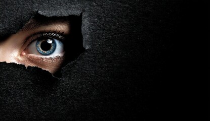 Eye peeking through dark hole