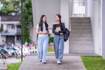 Two university students walking and talking on campus