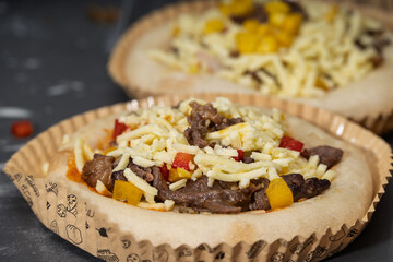 Delicious Beef and Vegetable Mini Pizzas with Cheese Topping